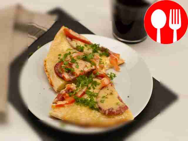 Разрежьте готовую пиццу на кусочки и подавайте к столу.